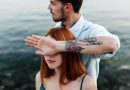 man in white dress shirt with tattoo on womans left cheek